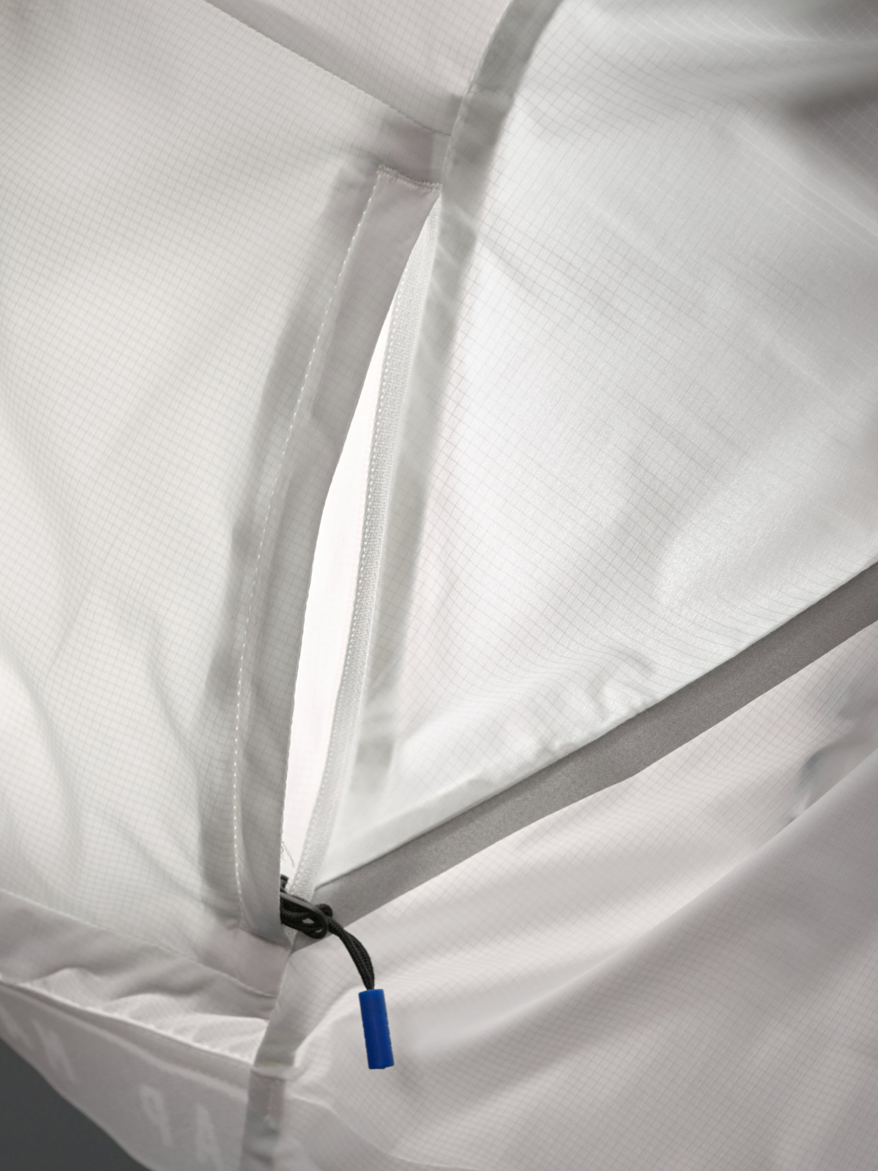 Women's Team Flow Jacket in Thistle: Secure storage with the zippered rear pocket, or use it to pack the jacket into itself f